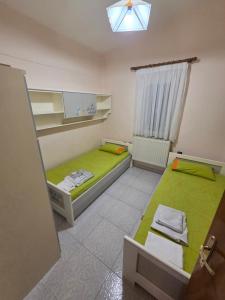a room with two beds and a window at iraklitsa house in Iraklitsa
