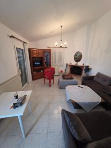 a living room with a couch and a table at iraklitsa house in Iraklitsa +4 photos