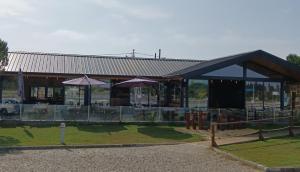 a building with a restaurant with tables and umbrellas at The Boat in Ovar