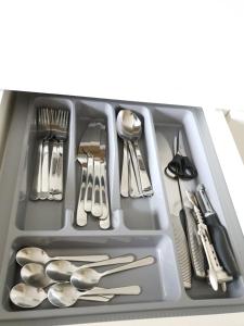 a tray with silver utensils in a drawer at Ezerkrasts Kempes 28 in Liepāja