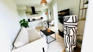 a living room with a white couch and a table at Penthouse Apartment in Kristiansand