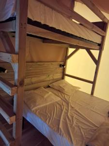 a bunk bed in a room with a bunk bedutenewayangering at Camping Au Bord de Loire in Gennes