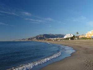 a view of a beach with buildings and the ocean at Ático Boutique con Piscina privada en el Solárium y Diseño Natural in Vera