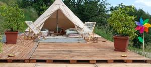 a tent with two chairs on a wooden deck at Glamping Casacocco' in San Ginesio