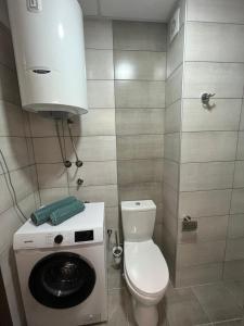 a small bathroom with a toilet and a washing machine at IL Paradiso potok akva park in Jagodina +20 photos