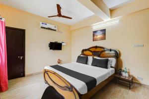 Postel nebo postele na pokoji v ubytování Super Hotel O Velachery Near Devi Karumariamman Nagar Extension