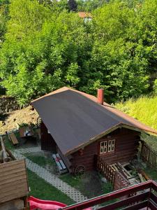 a small log cabin with a black roof at Rezydencja Karnat in Karpacz