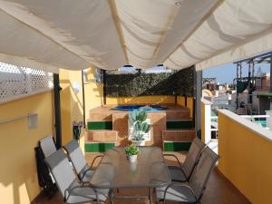 a patio with a table and chairs on a balcony at Preciso atico con jacuzzi en Laguna Beach in Vera