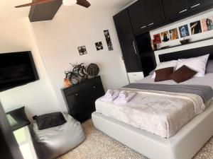 a bedroom with a bed with two pink slippers at Rijeka Fiorino Apartment in Rijeka