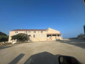 a shadow of a house on the side of a road at vue mer Studio 2/3 pers 1 bed + 1 cot in Farinole