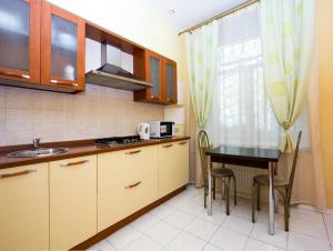 a kitchen with a table and a small table and chairs at ApartLux Park Pobedy 2 in Moscow