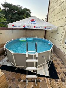 Una bañera con una silla junto a una piscina. en Apartment Registan, en Samarkand