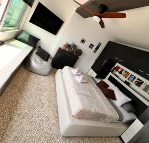 a bedroom with a bed and a ceiling fan at Rijeka Fiorino Apartment in Rijeka