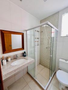 a bathroom with a shower and a sink at Recanto Serra e Mar in Angra dos Reis +30 photos