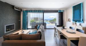 a living room with a couch and a table at Pentanemi Luxury Villa in Hanioti