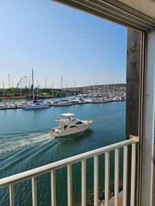 a boat in the water near a harbor with boats at La Cabane vue mer et port in Cap d'Agde
