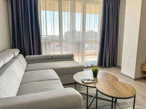 a living room with a couch and a table at 1BR Apartment with Panoramic View Balcony and Designated Parking Space in Plovdiv +36 photos