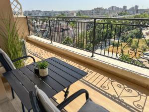 a table and chairs on a balcony with a view at 1BR Apartment with Panoramic View Balcony and Designated Parking Space in Plovdiv