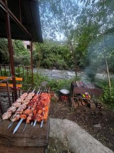 a grill with a bunch of meat and a fire at Gamma house in Verin Ptghni