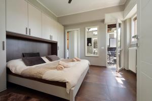 a bedroom with a large bed with white cabinets at Eur Trepini Luxury Loft in Rome