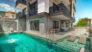 a house with a swimming pool in front of a house at Damira Apart in Demre