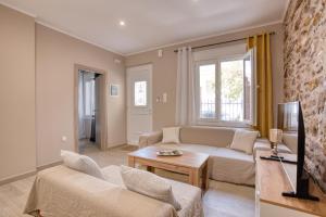 a living room with a couch and a tv at Pepita home in Chios