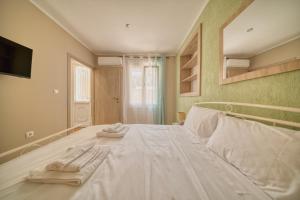 a bedroom with a bed with two towels on it at Pepita home in Chios