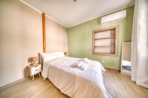 a bedroom with a white bed and a window at Pepita home in Chios +33 photos