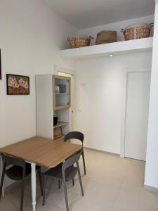 a dining room with a wooden table and chairs at Al Mare B&B in Fossacesia