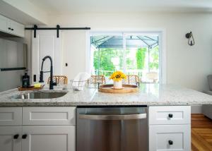 a kitchen with a counter top with a sink and a window at Lakeview Getaway with Hot Tub in Billerica