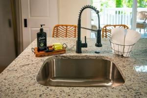a kitchen counter with a sink in a kitchen at Lakeview Getaway with Hot Tub in Billerica +48 photos
