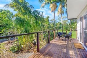 a wooden deck with two chairs and a table at South Golden Beach House - Tranquil Family Getaway in South Golden Beach