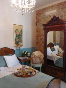 a bedroom with a mirror and a bed with a tray of food at Casa Dellatorre in Alba