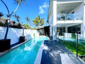 an exterior view of a house with a swimming pool at 4 Ensuites Patio Pool BBQ Billiards Media Room in Algester
