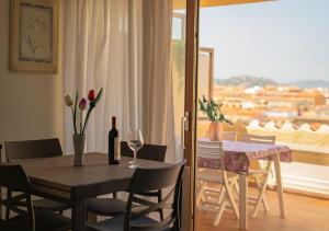 a dining room with a table and chairs and a window at Seaside Living - Sea View & Private Terrace in Palau +19 photos