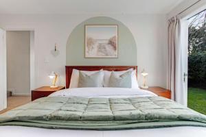 a bedroom with a large bed and a window at Perfect Family Home in Central Auckland in Auckland