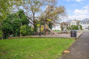 a playground with a slide in a park at Perfect Family Home in Central Auckland in Auckland