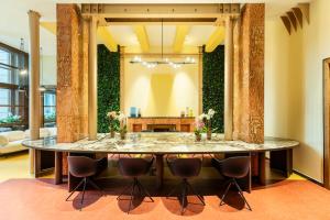 a dining room with a large table and chairs at 10 Manzoni Aparthotel in Cremona