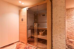 a walk in closet with a glass door at 10 Manzoni Aparthotel in Cremona