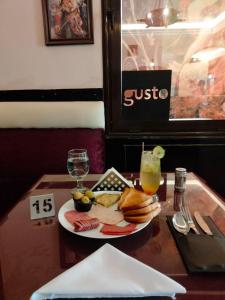 a plate of food and a drink on a table at Garden City Hotel Downtown in Cairo