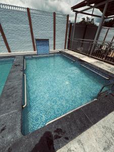 a swimming pool with a chair in a building at KS Valley in Rāmanagaram