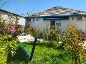 a garden with a swing in front of a house at VadooInn in Vadu