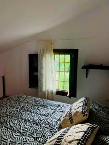 a bedroom with a bed and a window at La Casa de Cadia 2 in El Real de San Vicente