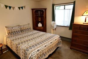 a bedroom with a bed and a window and a dresser at Forest Glen in Yosemite West
