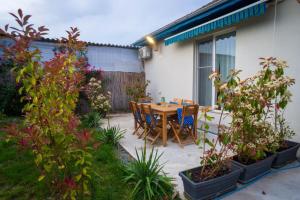 a patio with a table and chairs and plants at VadooInn in Vadu