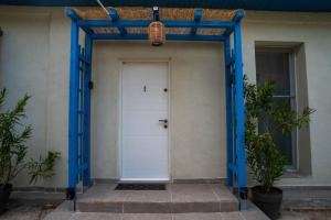 a door to a house with a blue frame at VadooInn in Vadu