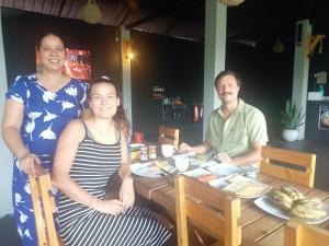 a group of three people sitting at a table at Mayka's luxury holiday homes and Safari Thanamalwila in Tanamalwila