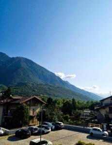 a parking lot with cars parked in front of a mountain at Borgo Emilius - CIR 0053 in Villefranche