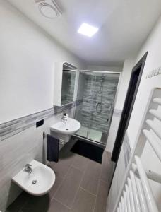 a bathroom with two sinks and a shower at Borgo Emilius - CIR 0053 in Villefranche
