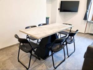 a conference room with a wooden table and chairs at Borgo Emilius - CIR 0053 in Villefranche +17 photos